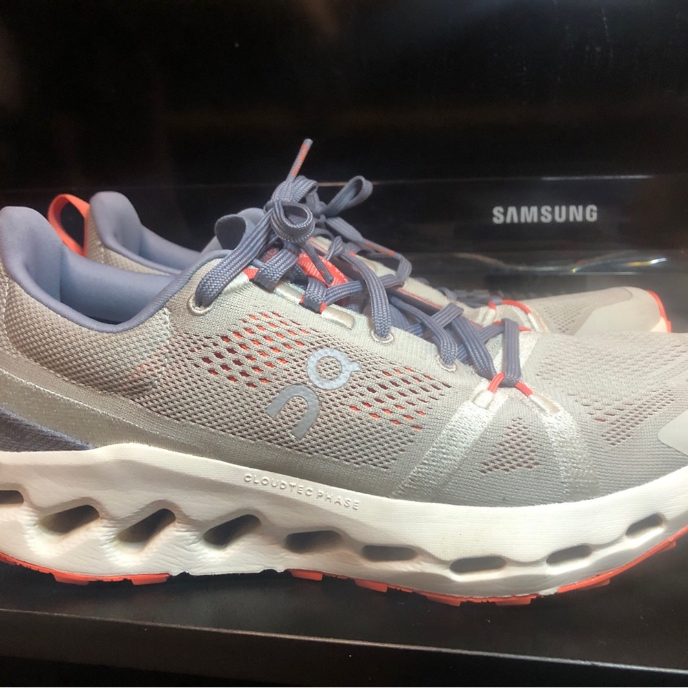 On Running Gray and Pink Athletic Shoes with Wave-Like Midsole